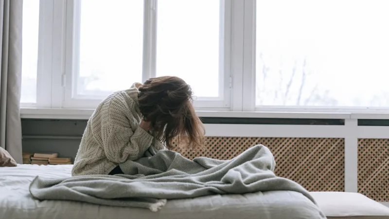 A Woman Sitting On A Bed (1)
