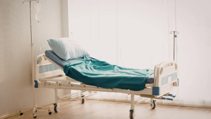 Empty Hospital Bed In A Clean Room